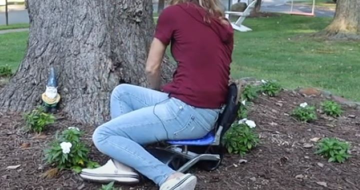Sitting down on the gardening stool with wheels